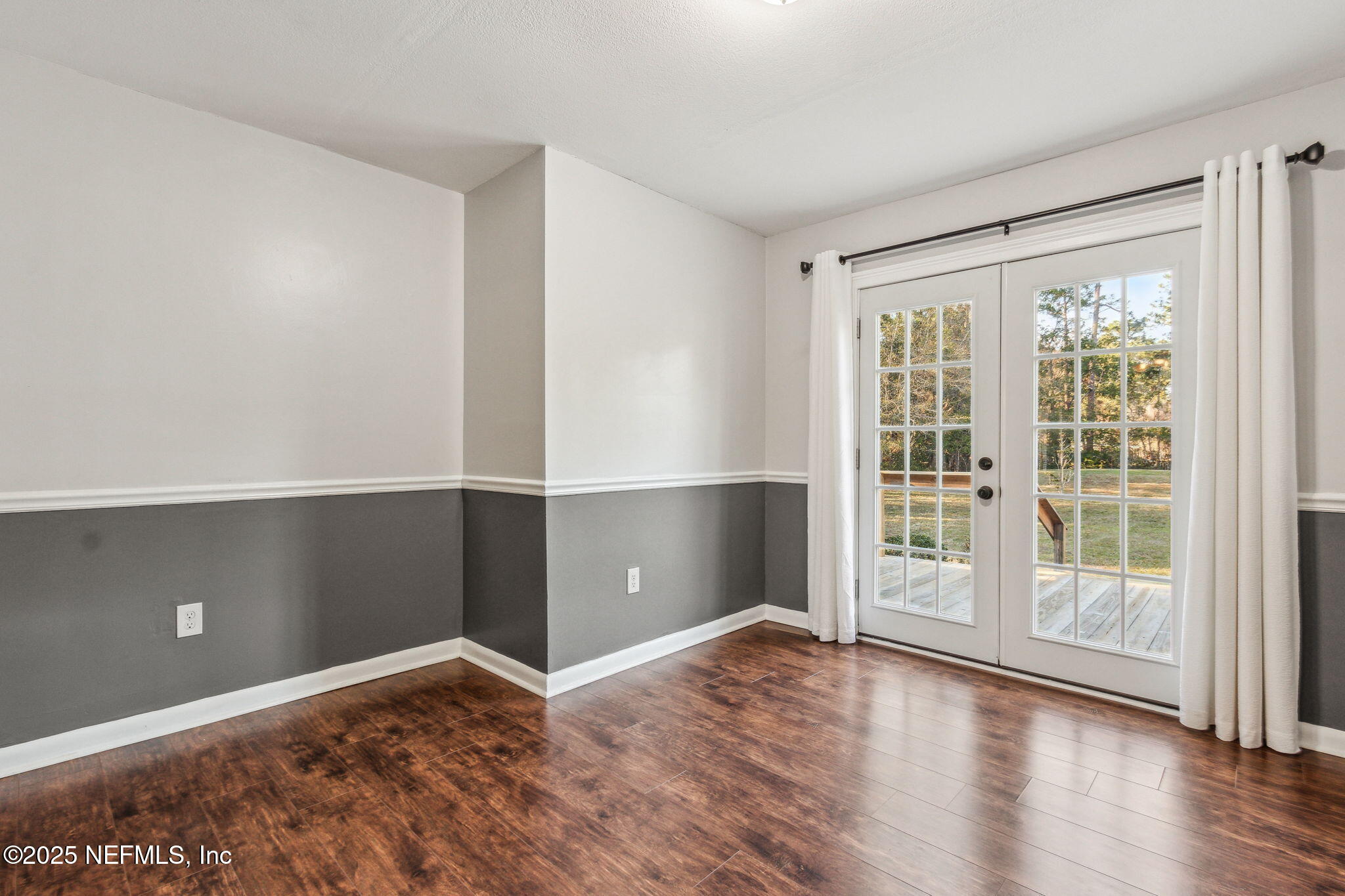 86221 Spring Meadow Avenue Yulee, FL 32097 - Photo 9 of 23 wooden floor in an empty room with a window