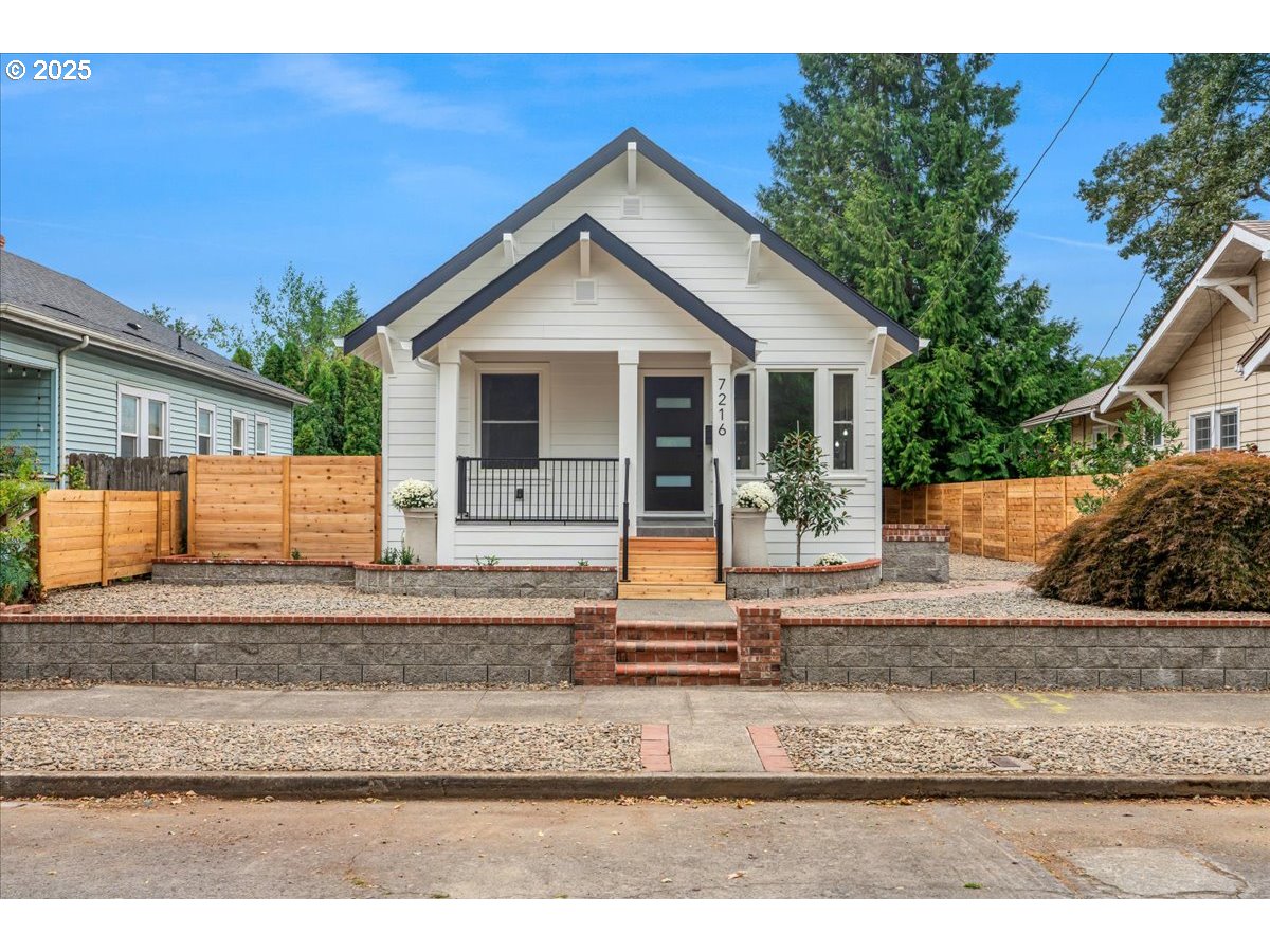 7216 North Ivanhoe Street Portland, OR 97203 - Photo 2 of 30 a front view of a house with garage and glass door