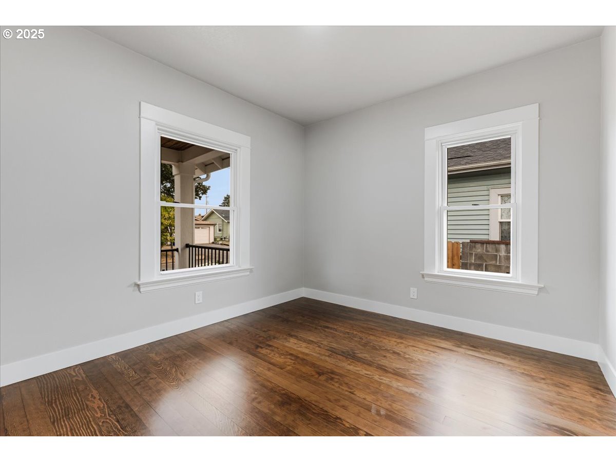 7216 North Ivanhoe Street Portland, OR 97203 - Photo 22 of 30 an empty room with wooden floor and windows