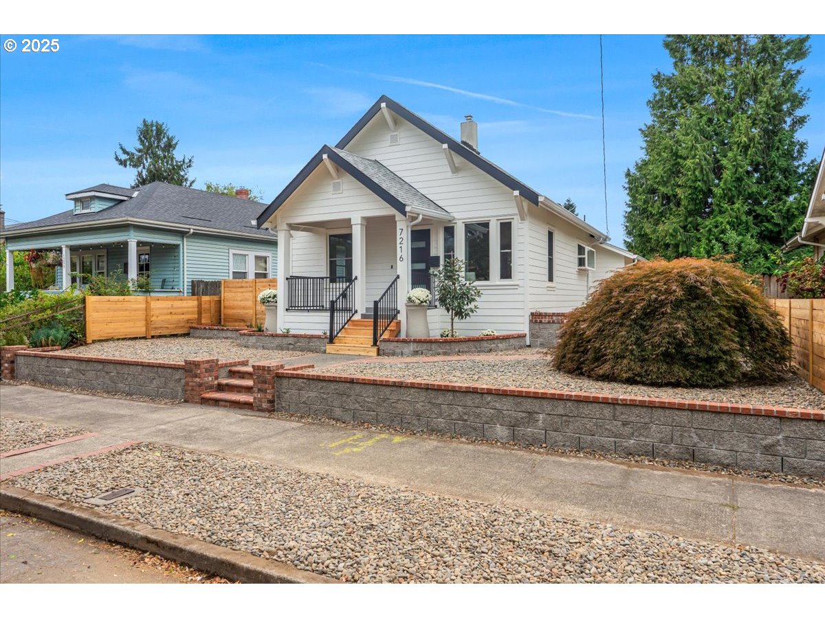 7216 North Ivanhoe Street Portland, OR 97203 - Photo 5 of 30 a front view of a house with a yard