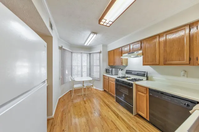 a kitchen with stainless steel appliances granite countertop a stove a sink dishwasher and a refrigerator