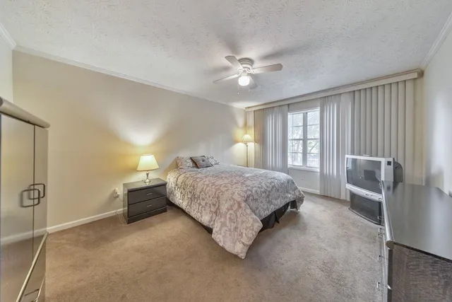 a bedroom with a bed lamps and a large mirror