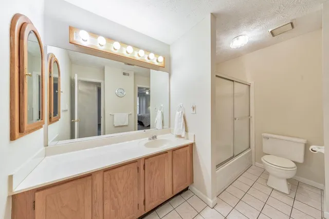a spacious bathroom with a double vanity sink mirror and toilet