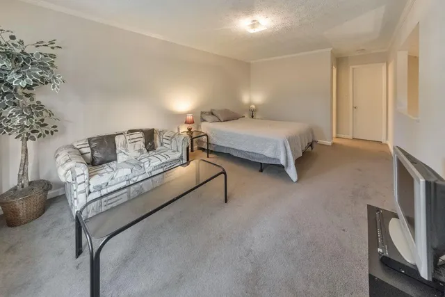 a bedroom with a bed and a chair