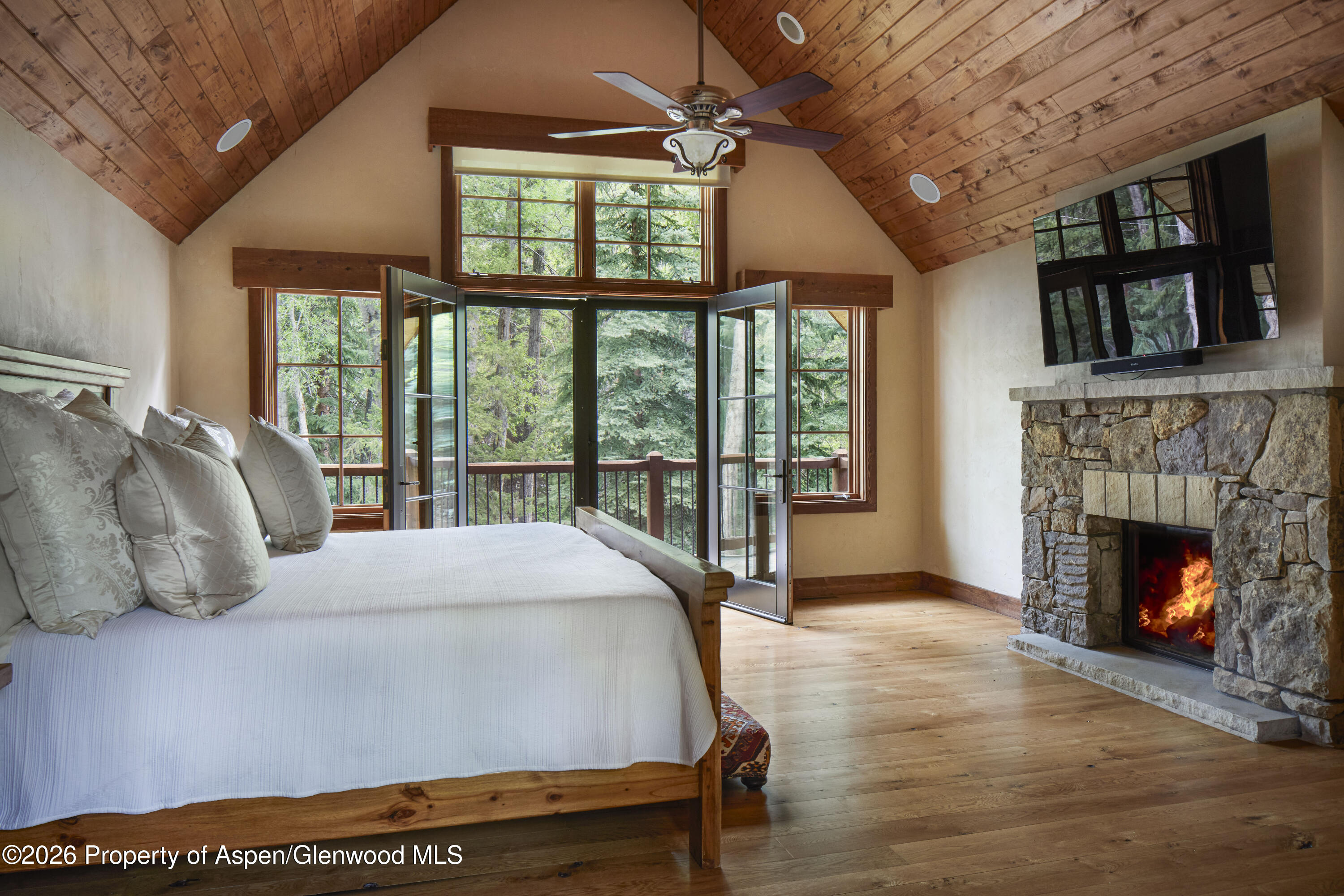 143 Conundrum Creek Road Aspen, CO 81611 - Photo 11 of 16 a bedroom with a bed and a fireplace