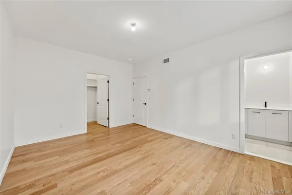a view of a room with wooden floor
