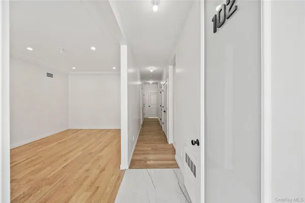 a view of a hallway with a wooden floor