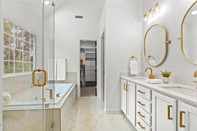 a kitchen with stainless steel appliances granite countertop a sink a stove and a wooden floors