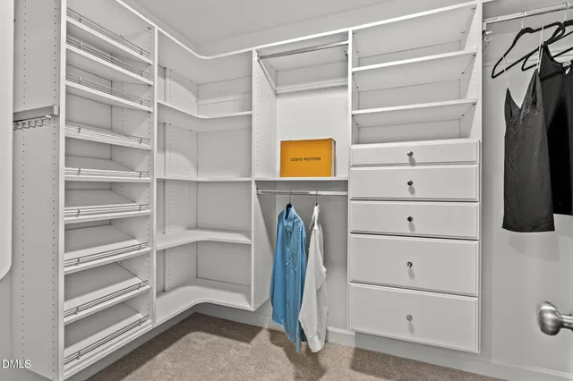 a view of walk in closet with empty racks