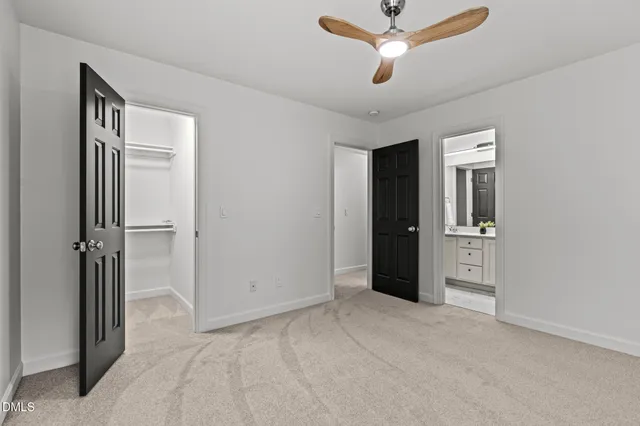 a view of a big room with closet and a chandelier fan