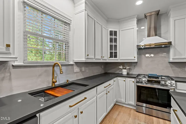 a kitchen with stainless steel appliances a stove a sink and a microwave