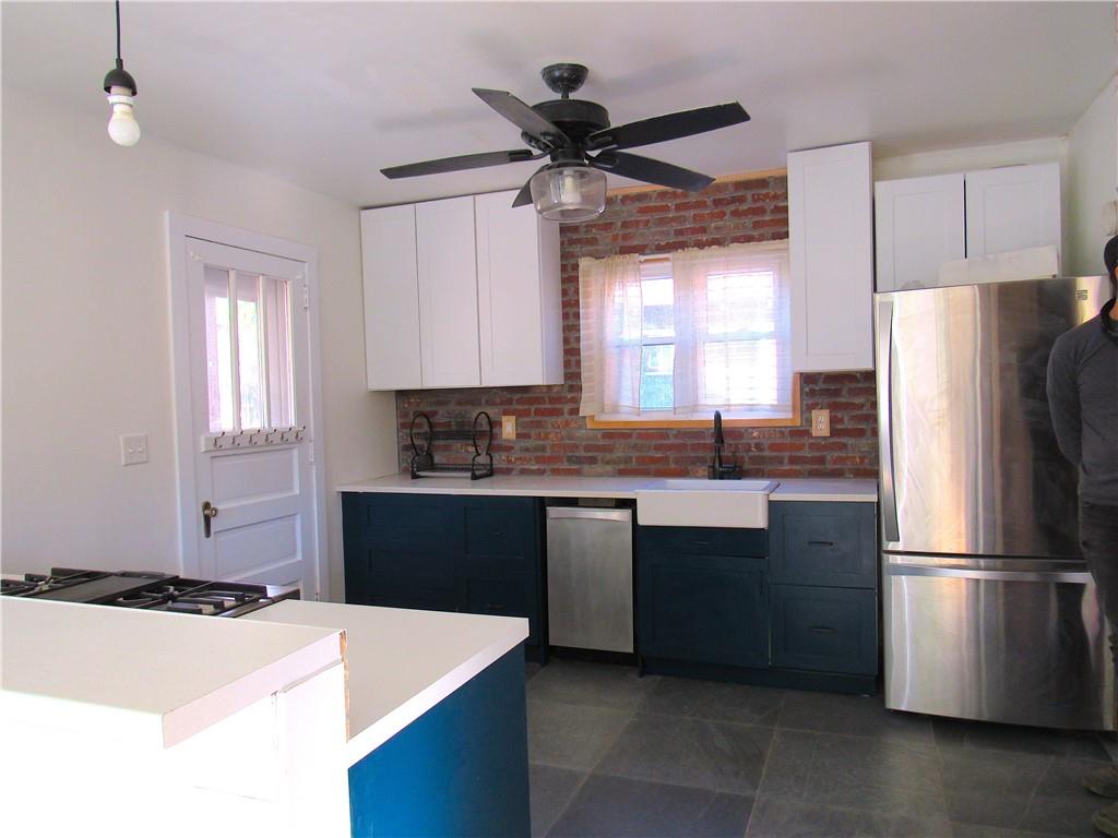 201 Friday Road Pittsburgh, PA 15209 - Photo 18 of 39 a kitchen with stainless steel appliances granite countertop a refrigerator a sink a stove a microwave and island
