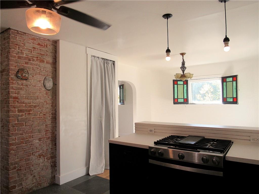 201 Friday Road Pittsburgh, PA 15209 - Photo 19 of 39 a kitchen with stainless steel appliances granite countertop a stove a sink and a refrigerator