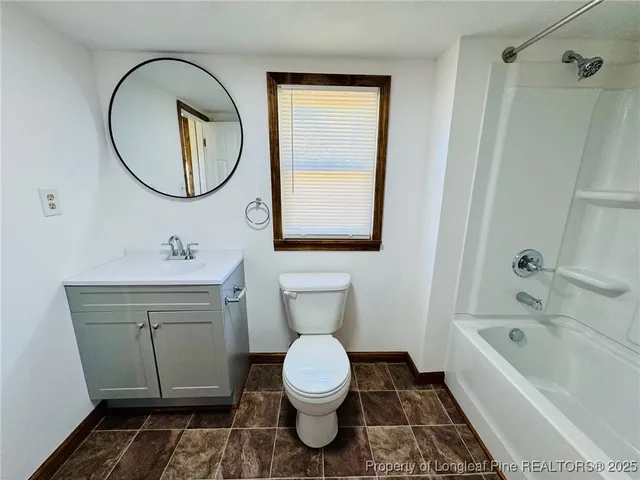 a bathroom with a toilet a sink and a mirror