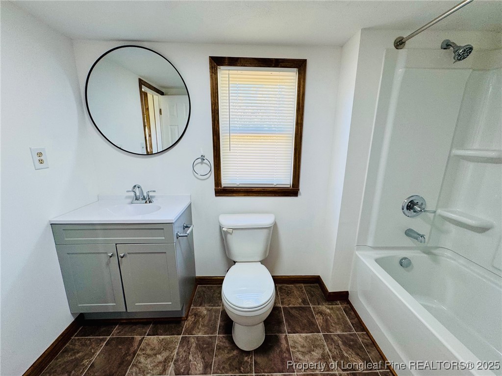 790 Old Whiteville Road Lumberton, NC 28358 - Photo 18 of 29 a bathroom with a toilet a sink and a mirror