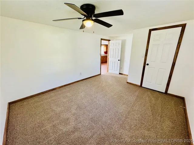 a view of a room with a ceiling fan