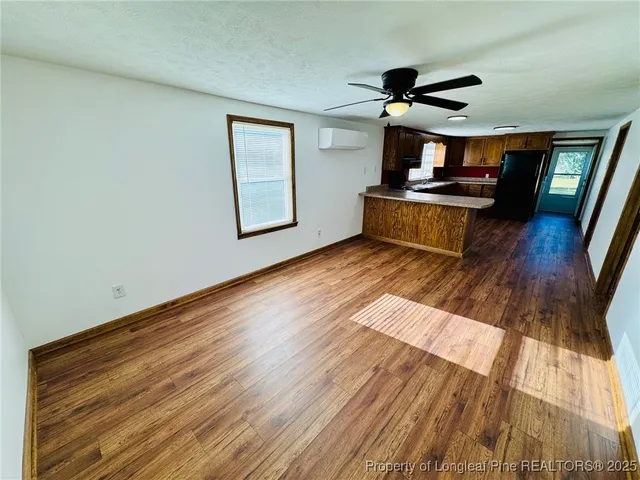 a view of a living room with wooden floor