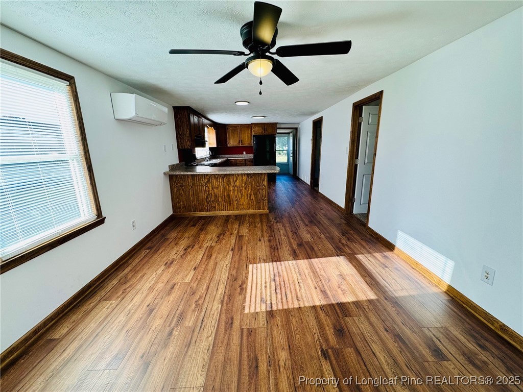 790 Old Whiteville Road Lumberton, NC 28358 - Photo 4 of 29 a view of a living room with wooden floor and a ceiling fan