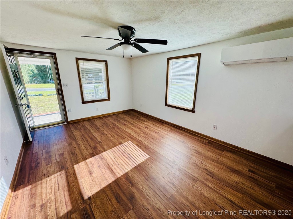 790 Old Whiteville Road Lumberton, NC 28358 - Photo 6 of 29 a view of an empty room with a window and wooden floor