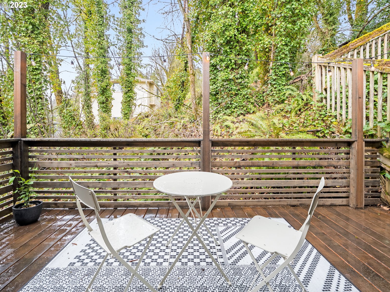 5928 Southwest Yamhill Street Portland, OR 97221 - Photo 21 of 25 a balcony with table and chairs