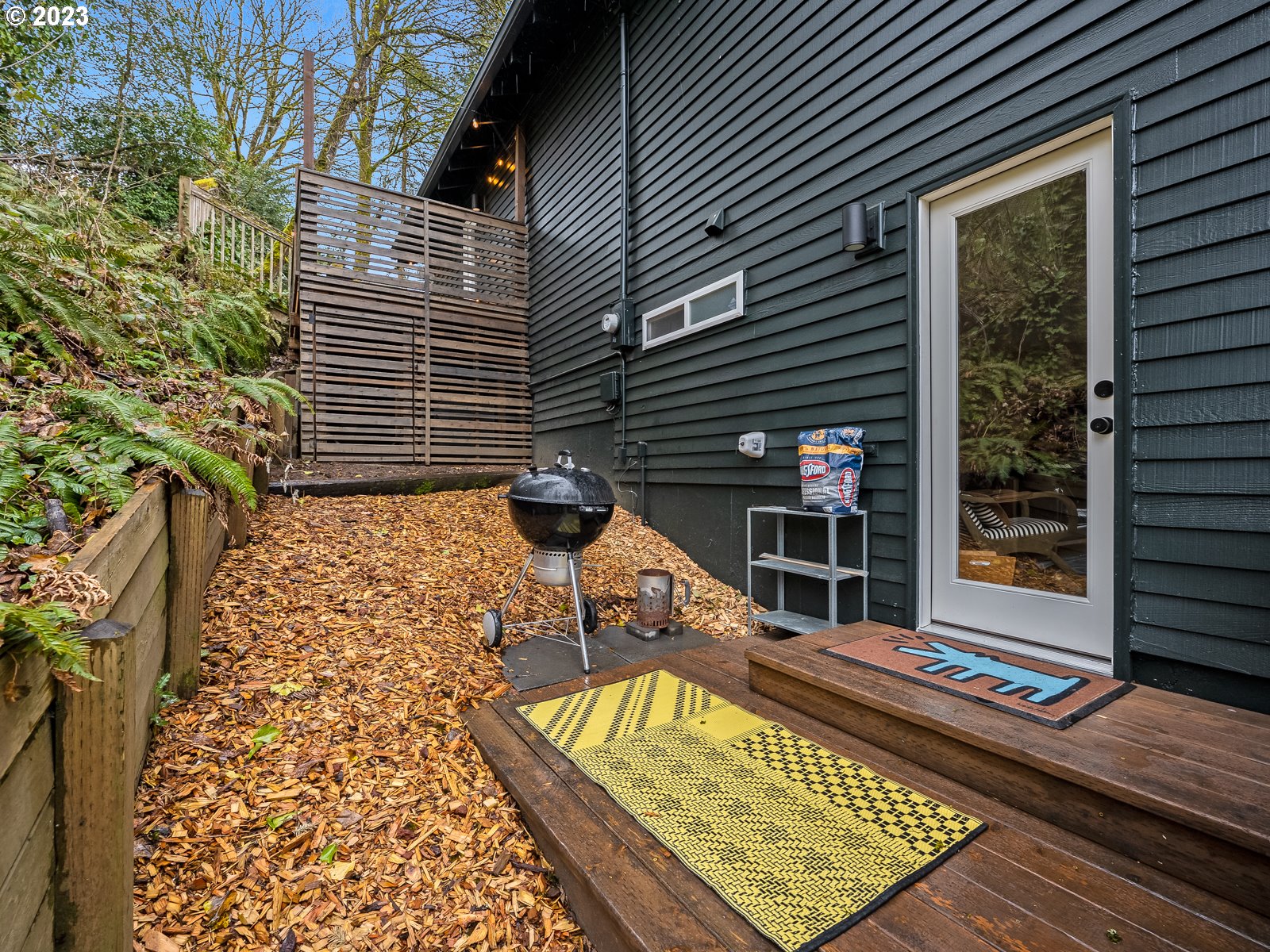 5928 Southwest Yamhill Street Portland, OR 97221 - Photo 22 of 25 a view of a chairs and table on the wooden deck