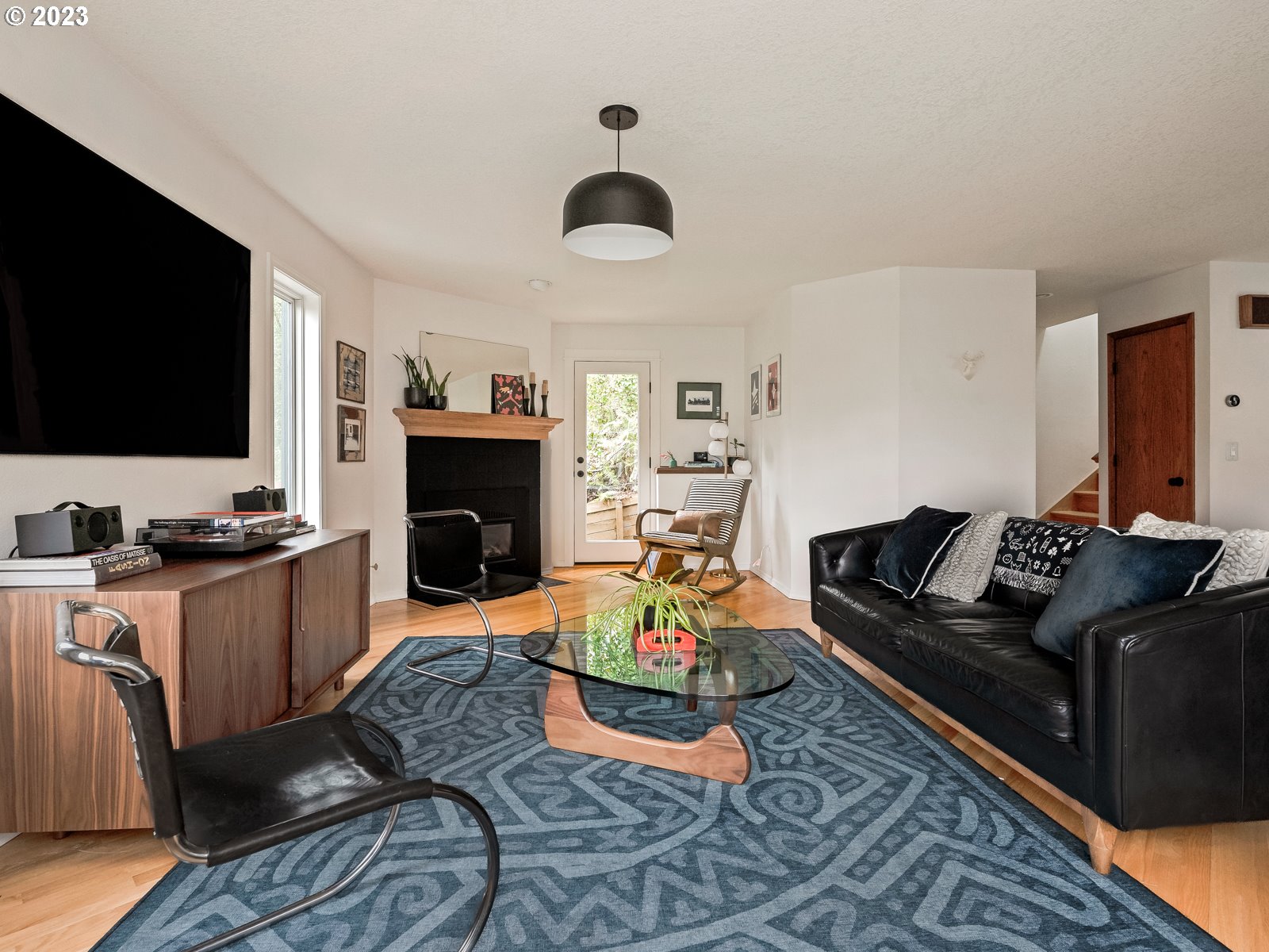 5928 Southwest Yamhill Street Portland, OR 97221 - Photo 4 of 25 a living room with furniture flat screen tv and a fireplace