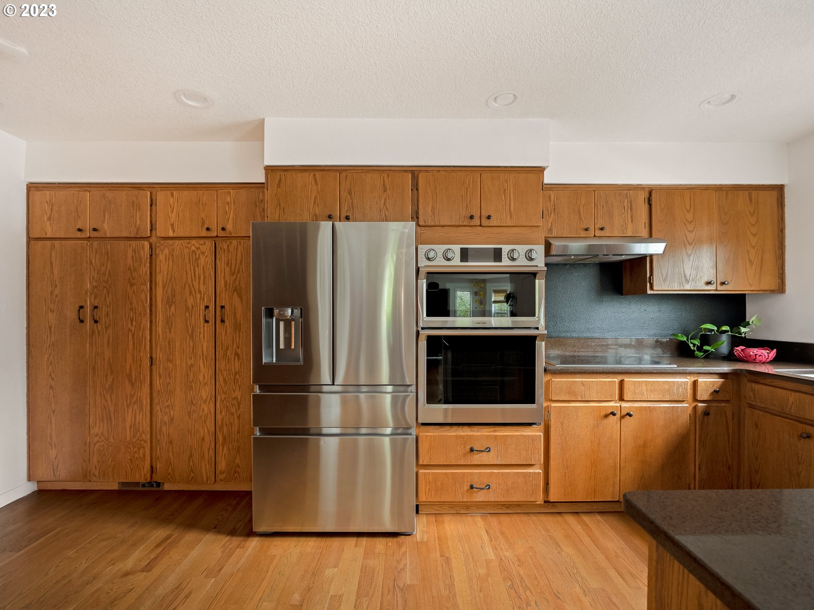 5928 Southwest Yamhill Street Portland, OR 97221 - Photo 6 of 25 a kitchen with stainless steel appliances a refrigerator and a stove top oven