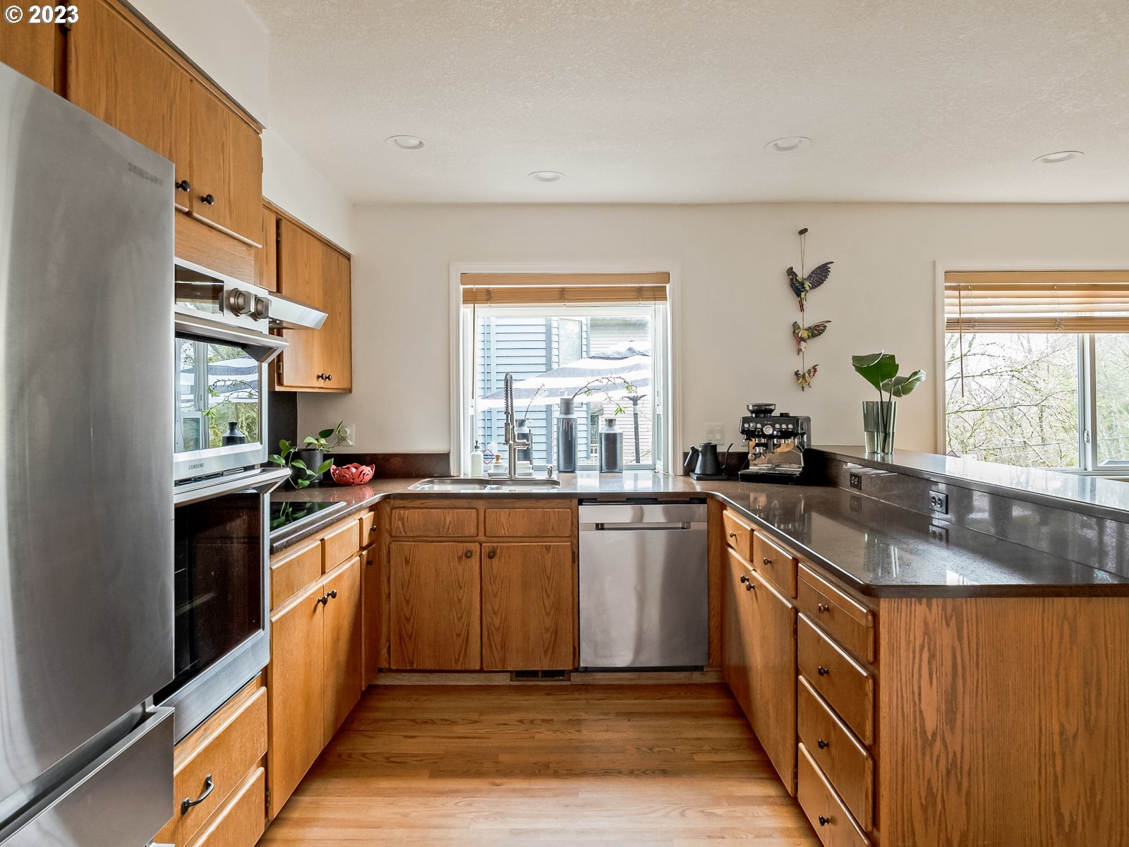 5928 Southwest Yamhill Street Portland, OR 97221 - Photo 7 of 25 a kitchen with stainless steel appliances granite countertop a sink stove and refrigerator