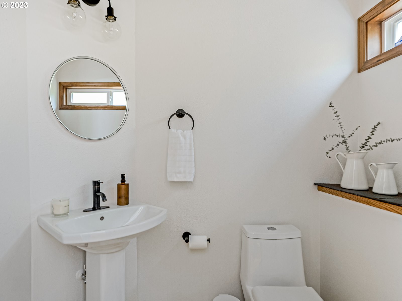 5928 Southwest Yamhill Street Portland, OR 97221 - Photo 8 of 25 a bathroom with a toilet a sink and mirror