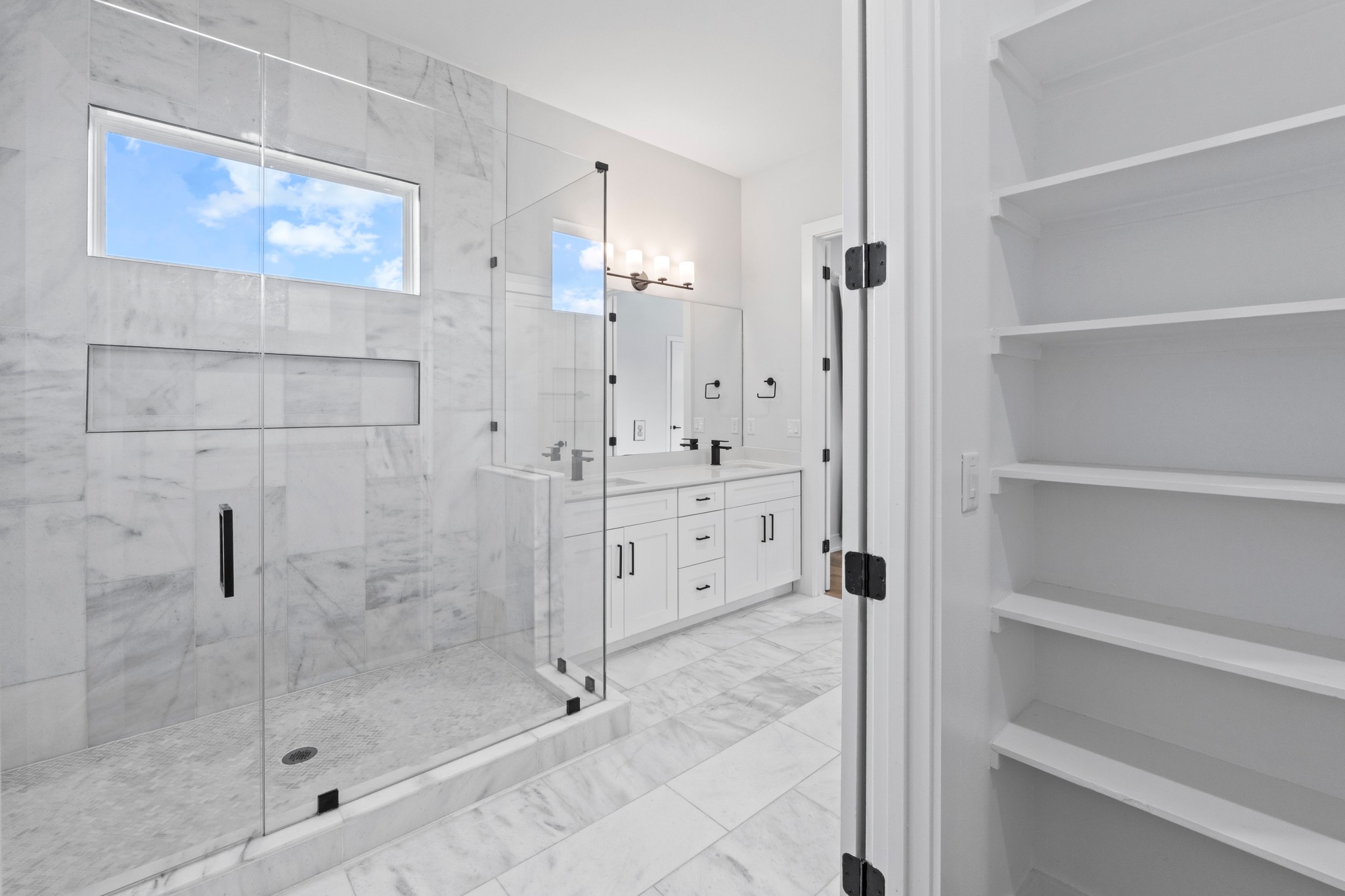 2007 Chestnut Avenue, Unit 1 Austin, TX 78722 - Photo 23 of 32 Marble-clad bathroom features a spacious glass-enclosed shower and dual vanity with ample storage.