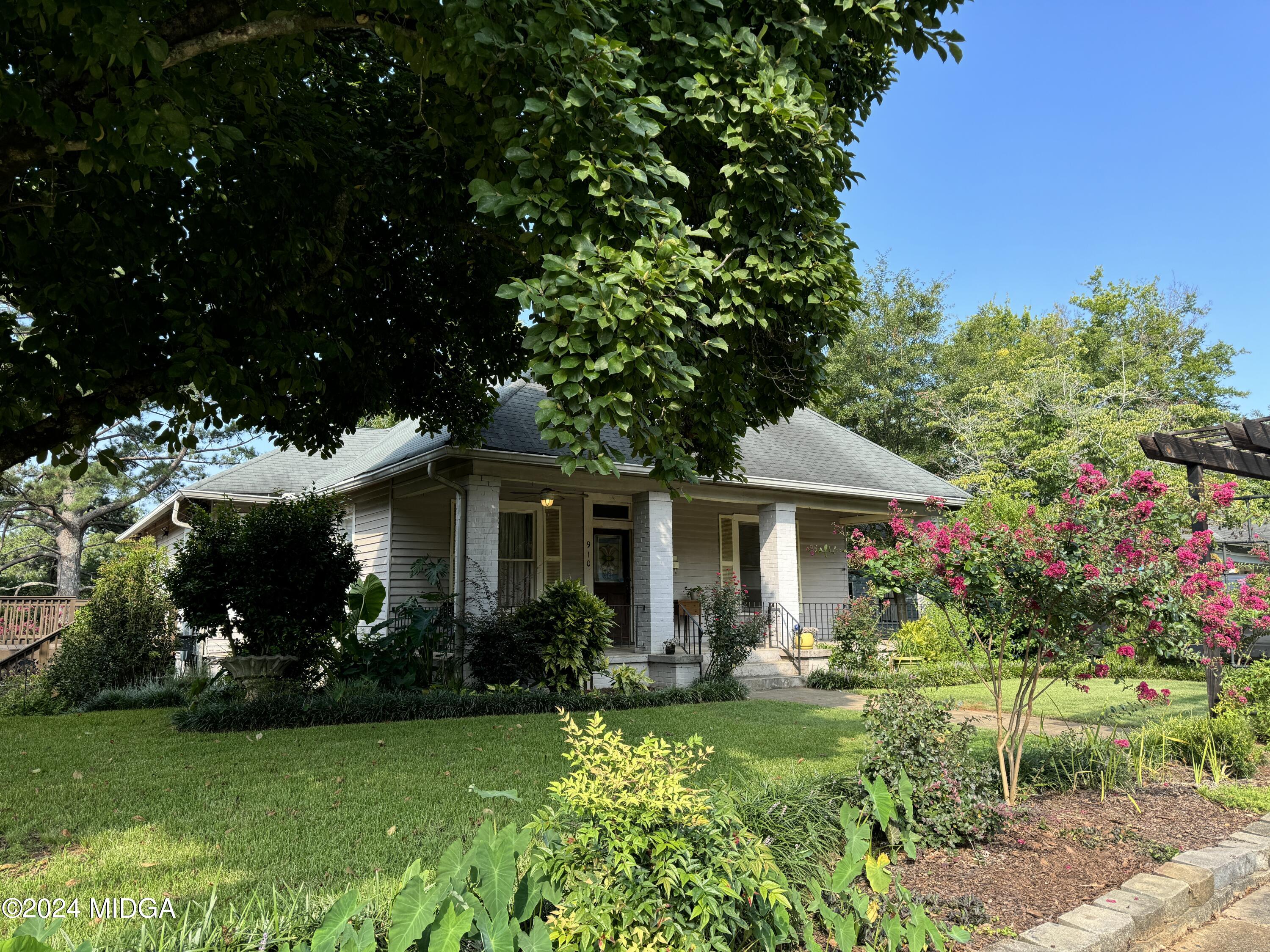 a front view of a house with garden
