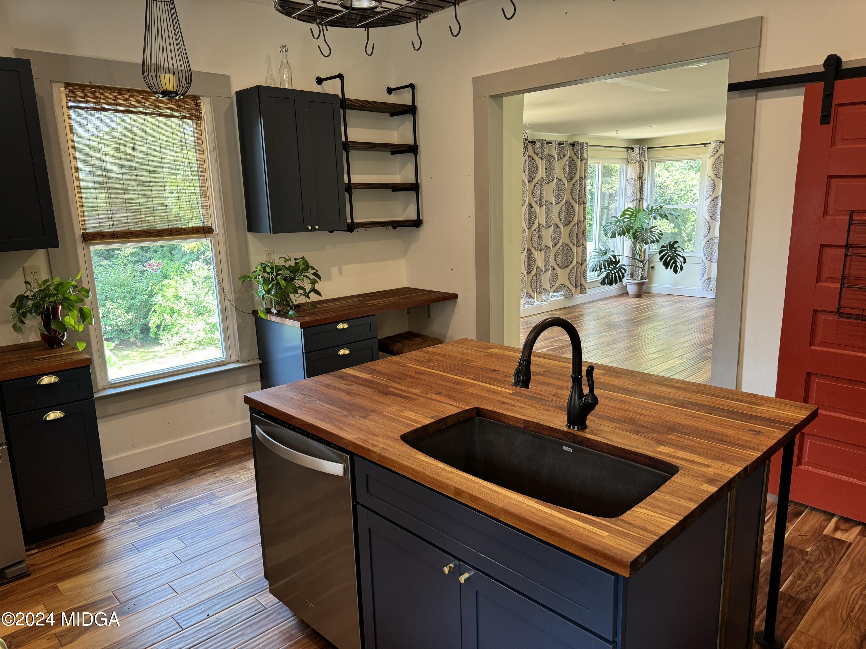 910 Laurel Avenue Macon, GA 31211 - Photo 11 of 41 a kitchen with a sink and wooden floor