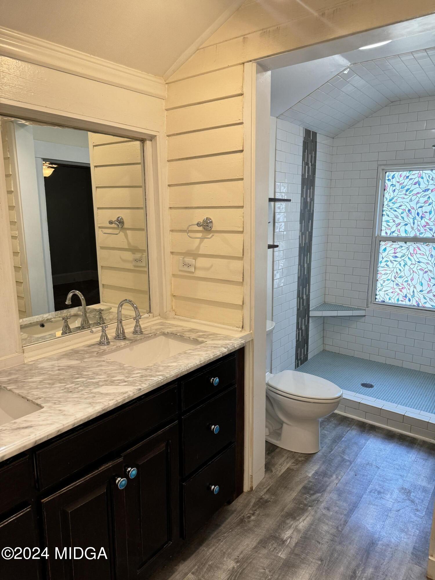 910 Laurel Avenue Macon, GA 31211 - Photo 17 of 41 a bathroom with a granite countertop sink toilet and shower