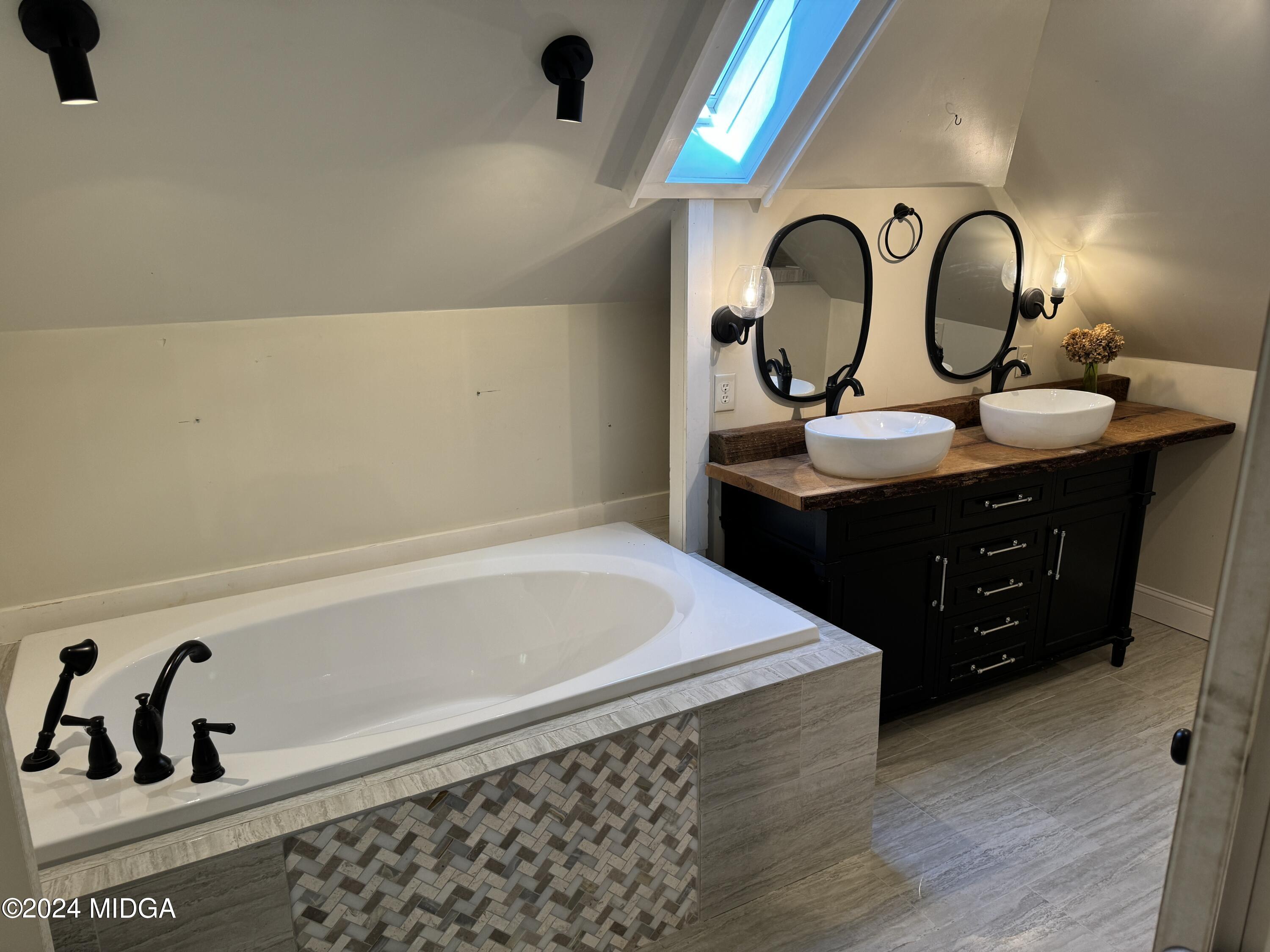 910 Laurel Avenue Macon, GA 31211 - Photo 25 of 41 a bathroom with a sink and a mirror