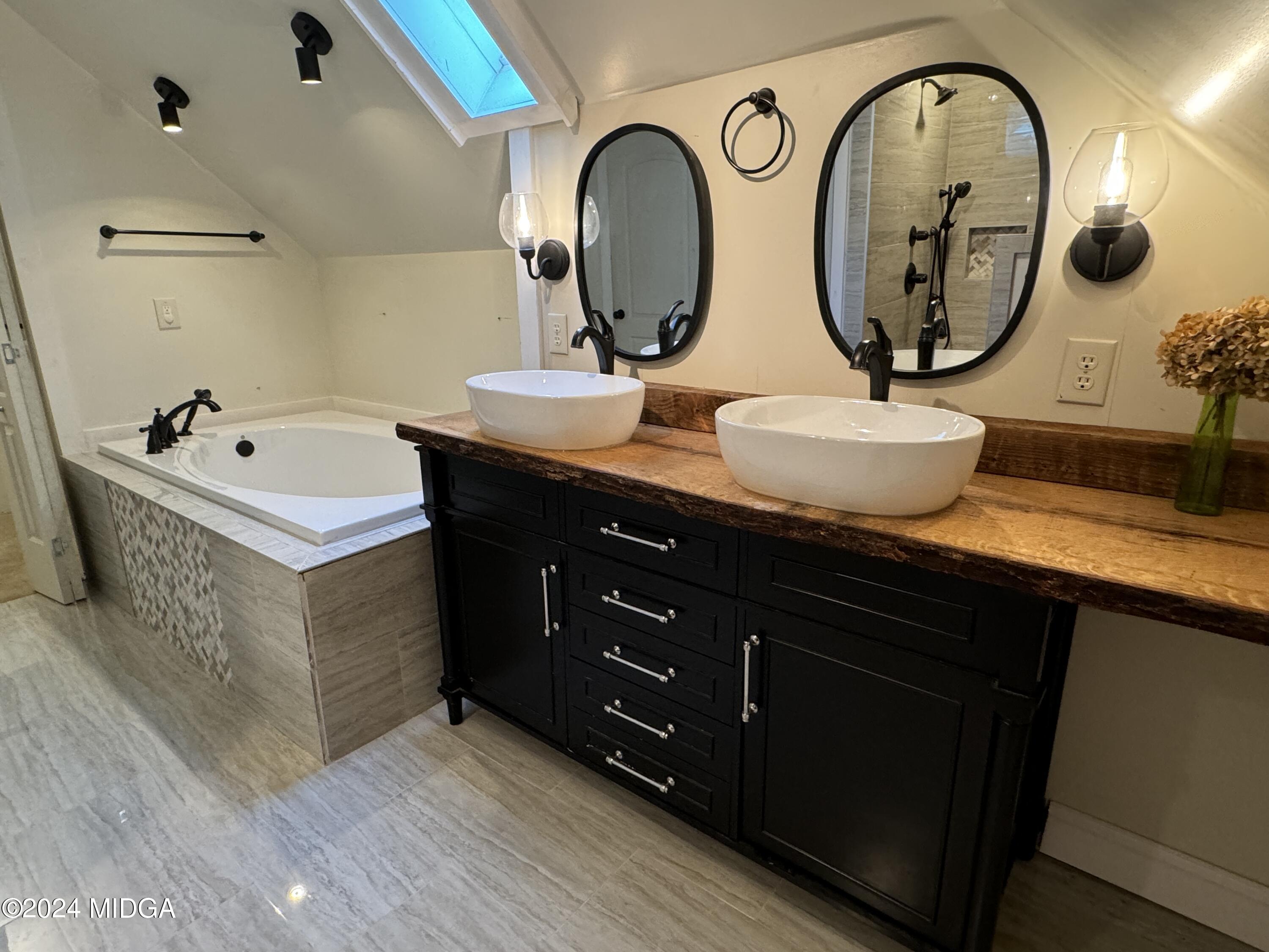910 Laurel Avenue Macon, GA 31211 - Photo 27 of 41 a bathroom with a double vanity sink and a mirror