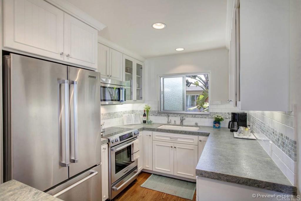 155 15th Street, Unit 19 Del Mar, CA 92014 - Photo 4 of 29 a kitchen with a sink stove and refrigerator