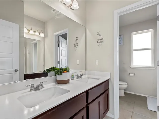 a bathroom with a sink double vanity and a mirror