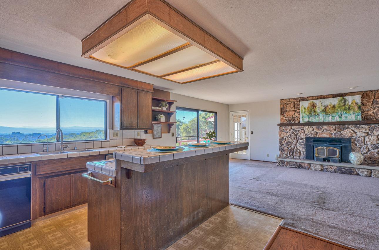 8640 Coker Road Salinas, CA 93907 - Photo 11 of 50 a kitchen with kitchen island a stove a sink and a living room view