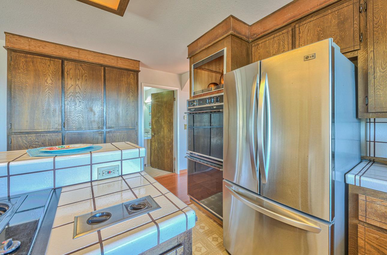 8640 Coker Road Salinas, CA 93907 - Photo 14 of 50 a kitchen with stainless steel appliances granite countertop a refrigerator and a stove