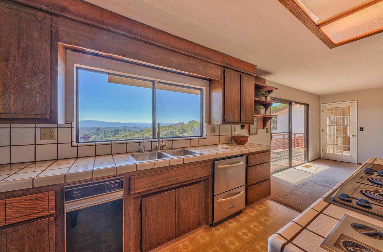 8640 Coker Road Salinas, CA 93907 - Photo 15 of 50 a kitchen with a sink stove and cabinets