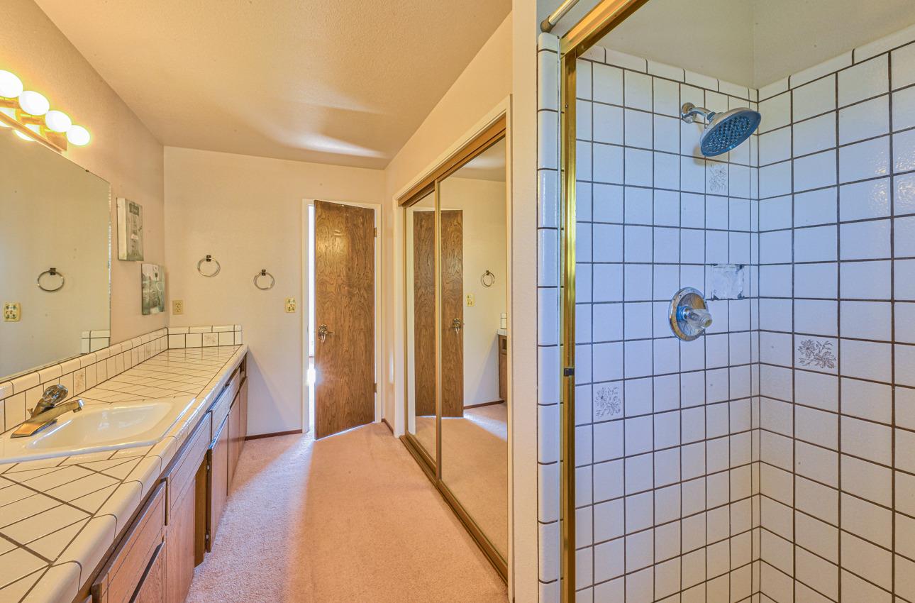 8640 Coker Road Salinas, CA 93907 - Photo 42 of 50 a bathroom with a double vanity sink a toilet and shower