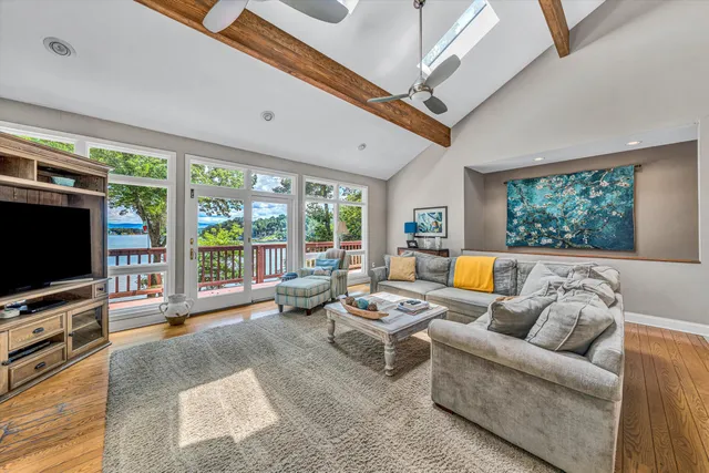 a dining room with furniture a chandelier and wooden floor