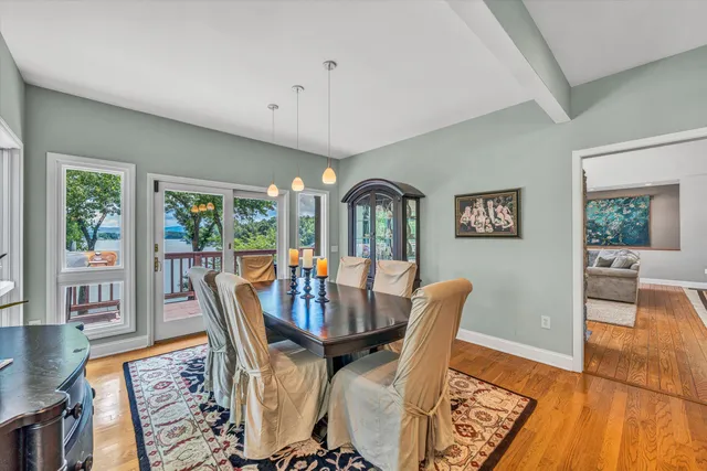 a kitchen with stainless steel appliances granite countertop a table and chairs in it