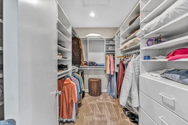 a view of washer and dryer with bathroom in the background