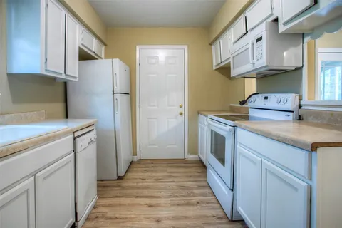 a kitchen with stainless steel appliances a stove a refrigerator and a cabinets