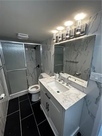 a bathroom with a sink toilet and shower