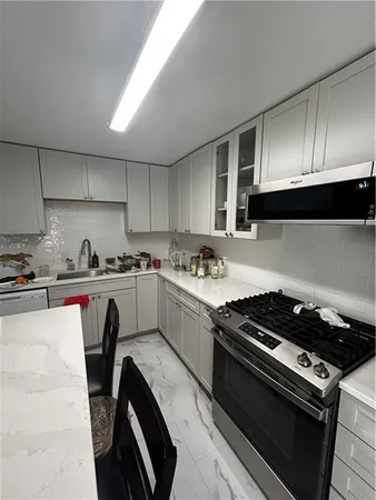 a kitchen with a stove a sink and a refrigerator