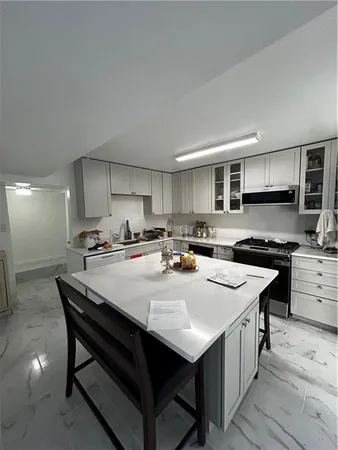a kitchen with appliances a sink and cabinets