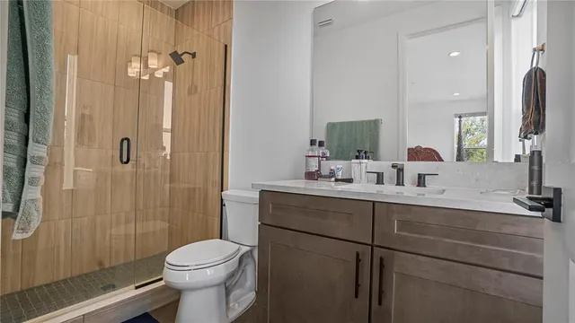 a bathroom with a sink a toilet and shower