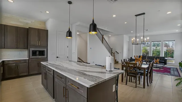 a kitchen with stainless steel appliances granite countertop sink stove and wooden floor